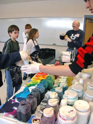 ORR's Color Creations
Students in Ms. Gauvins eighth grade science class at Old Rochester Regional Junior High School learned about chemical reactions and colors during a tie-dye shirt-making session held this past week. UMass Dartmouth Chemistry Professor Tobey Dills (right background) and members of the UMass Dartmouth Chemistry Club were on hand to supervise the proceedings. Each student made their own cotton tie-dyed shirt which they will wear to school as part of a planned Tie-Dyed Day. (Photo by Kenneth J. Souza).
