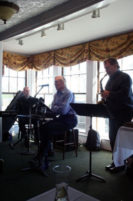 Poetic Jazz
Ellen Flynn and members of the Friends of the Mattapoisett Library welcomed poet Franklin D. Reeve to the Kinsale Inn in Mattapoisett on Sunday April 5 as part of the library's celebration of National Poetry Month. Mr. Reeve performed his piece, The Blue Cat Walks the Earth, accompianied by improvisational jazz muscians Don Davis and Joe Deleault in a performance dedicated to the memory of the late Library Director Judy Wallace. (Photo by Robert Chiarito)
