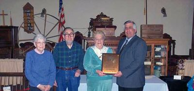 Posting Rochester History
Rochester Post Office Officer-In-Charge Michael Proulx recently presented a plaque to members of the Rochester Historical Society. The award was prompted by a display of several interesting articles set up by committee members at the Rochester Post Office. The collection includes 17 framed black and white pictures of various town landmarks. Those interested in viewing the collection may do so Monday through Friday, 6:30 am to 5:00 pm, and Saturday 6:30 am to 1:00 pm.
