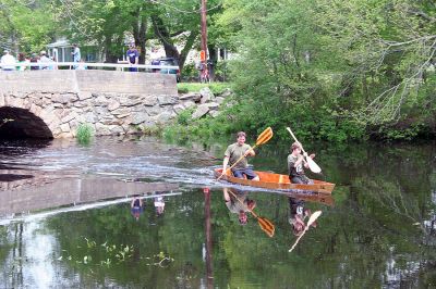 Team Spirit
Alex Buckley and Matt Buckley, both of Mattapoisett, make their way under the arch bridge in Mattapoisett for the final stretch of the Memorial Day Boat Race held on Monday, May 28. (Photo by Robert Chiarito).
