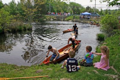 River's End
Three teams coast through the finish line and prepare to disembark from their handmade wooden boats during the 2007 Memorial Day Boat Race on the Mattapoisett River. (Photo by Robert Chiarito).
