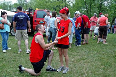 Smooth Sailing
M.J. Linane of Saugus, MA, found a unique way to propose to his new fiancee, Elise Goyette of Rochester. As the two made their way down the Mattapoisett River during this year's Memorial Day Boat Race, family members posted a banner on the arch bridge in Mattapoisett, asking Elise if she would marry M.J. Here M.J. makes a more formal proposal after completing the race. (Photo by Tim Smith).
