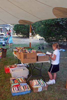 Book Bargains
Book lovers had a chance to find a good read or two as the Friends of the Joseph Plumb Memorial Library in Rochester held their annual book sale under a tent on the librarys lawn on Saturday, September 8. Bargain hunters have been flocking to this event for years in search of the perfect book and this sale was no exception with shoppers arriving bright and early to get the first crack at box upon box of reading pleasures all priced at $2 or less. (Photo by Robert Chiarito).
