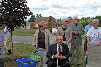 COA Memorial Tree Planting
George Church listens on while flanked by family members and friends as a tree is dedicated in memory of his wife, former longtime COA board member Katherine Church, on property adjacent to the Rochester Senior Center. (Photo by Kenneth J. Souza).
