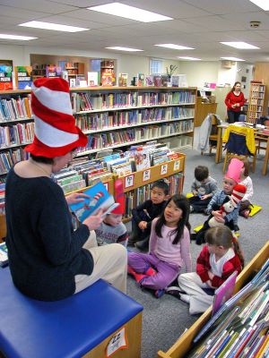 Party Hat in Rochester
Children listen attentively to Plumb Memorial Library Director Gail Roberts as she reads aloud from Dr. Seuss classic The Cat in the Hat. The Rochester library held a Birthday Party commemorating the 50th anniversary of the books release which included fun, games and treats for all participants. The books author, the late Theodore Giesel, was a native of Springfield, MA. (Photo by Robert Chiarito).
