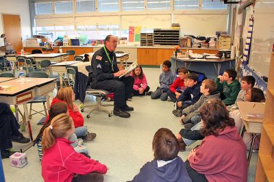 Readers in Rochester
Rochester Police Sergeant William Chamberlain reads to students at Rochester's Memorial School during the recent "Reading is Fundamental" guest reader program. (Photo by Robert Chiarito).
