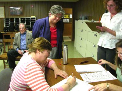 Rochester Recount
Newly-elected Rochester Selectman Dan McGaffey (background) looks on while his wife Kathryn observes a hand recount of the election ballots. (Photo by Kenneth J. Souza).
