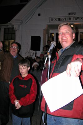 Tree Lighting Winner
Christian Brown of Memorial School in Rochester (pictured here with Selectman Dan McGaffey, left background, and Selectman Bradford Morse, right foreground) won a school-sponsored drawing contest in which he earned the honor to officially light the town Christmas tree during the Annual Tree Lighting Ceremony held on Monday, December 11, 2006 at the Rochester Town Hall. (Photo by Kenneth J. Souza).
