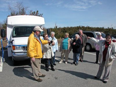 Rochester's New Wheels
Town officials and members of the Rochester Council on Aging (COA) Board of Directors poured non-alcoholic champagne over the hood of the newly-dedicated COA minibus which the town acquired through a rebate they received from MBTA funds during a dedication ceremony held on Friday, March 30. The new 14-passenger vehicle can also accommodate two wheelchairs and will be used to transport seniors to various events. (Photo by Kenneth J. Souza).

