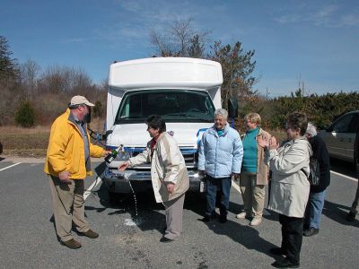 Rochester's New Wheels
Rochester Selectman Dan McGaffey (far left) and Council on Aging (COA) Director Sharon Lally (second from left) pour non-alcoholic champagne over the hood of the newly-dedicated COA minibus which the town acquired through a rebate they received from MBTA funds while other members of the COA Board of Directors look on. The new 14-passenger vehicle can also accommodate two wheelchairs and will be used to transport seniors to various events. (Photo by Kenneth J. Souza).
