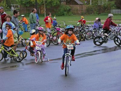 Tri-Town Bike Benefit
Several hundred children and their parents braved soggy conditions to participate in the first annual Pan-Mass Challenge (PMC) Tri-Town Ride for Kids on Saturday, May 19 starting at Center School on Barstow Street in Mattapoisett. The young bikers arrived with the goal of pedaling their way towards raising $10,000 in the fight to find a cure for cancer. Children ranging in age from 3 to 15 years were encouraged to participate in the bike rally benefit. (Photo by Robert Chiarito).
