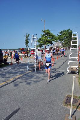Triple Threat
Brian Hughes of Randolph, MA crosses the finish line in the 2008 Mattapoisett Lions Club Triathlon on Sunday, July 13 to take both first place overall and first male honors. (Photo by Robert Chiarito).
