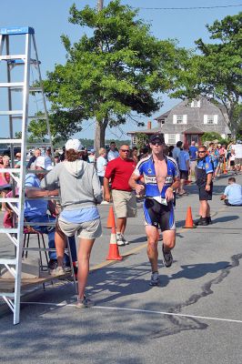 Triple Threat
The 2008 running of the Mattapoisett Lions Club Triathlon was held at the Mattapoisett Town Beach on Sunday morning, July 13, beginning at 8:00 am. This year 173 participants attempted the triple event which began with a swim in Mattapoisett Harbor, a bike ride into the town village, and a marathon back to the Town Beach. (Photo by Robert Chiarito).
