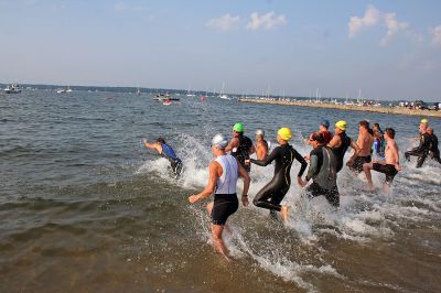 Triple Challenge
Participants in the 2007 Mattapoisett Lions Club Triathlon enter the waters of Mattapoisett Harbor for the first leg of the three-part challenge held on Sunday morning, July 15. (Photo by Robert Chiarito).
