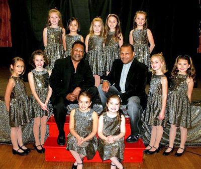 Tiny and Tots
Ralph and Tiny Tavares of the acclaimed New Bedford-based group Tavares pose with the Music Minors from Voices in Time, based in Rochester. The Music Minors are the youngest group members and range in age from five to eight. The group will be performing with the Tavares brothers as part of a Motown Christmas Cabaret on Sunday, December 21 at 6:00 pm at the Knights of Columbus Hall on Route 6 in Mattapoisett. (Photo courtesy of Marlene Kalisz).

