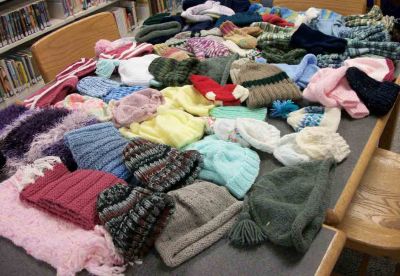 Plumb Knitters
The Knitters at Plumb Library have done it again. Last year, they donated 185 scarves for soldiers. This year, the Rochester knitters made items for children, donating 46 caps for preemies at Charlton Hospital, and 19 pairs of mittens, 40 hats, 23 scarves, one sweater, and one pair of socks for "Gifts to Give" in New Bedford. Photo courtesy of Gail Roberts.
