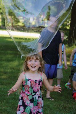 Keeping it cool
Kids gathered outside the Joseph H. Plumb Memorial Library on Friday, July 21, chilling in the shade drenched in bubble stuff with Vinny the Bubble Guy. Photos by Jean Perry

