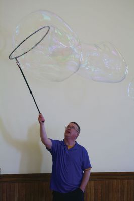Bubbles, bubbles, everywhere! 
Kids were spellbound by Keith Johnson and his “Bubbleology” show at the Marion Music Hall on June 22, sponsored by the Elizabeth Taber Library. Ty Mackenzie, 9, was the lucky one who got to be swallowed up by a giant bubble. Photos by Jean Perry
