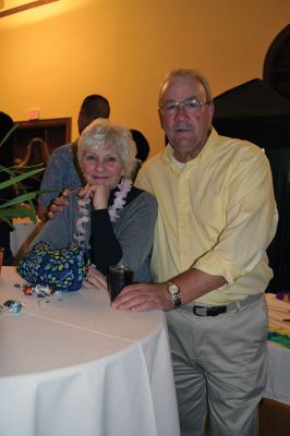 Fireworks Gala
People were still trickling in at 8:00 pm as the Marion Fireworks Committee’s second annual beach party on April 5 started picking up the pace with music and lights provided by Fun 107’s Michael Rock, and guests holding drinks with little umbrellas began shaking their hips. There was the scent of tropical coconutty sunblock in the air as guests perused the items up for auction, including a luxury African photo safari valued at $5,500. Photo by Jean Perry
