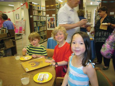 Judy Kleven Retires
Scores of admirers gathered on Friday to celebrate the service of Head Librarian Judy Kleven, who retired after 27 years at Elizabeth Taber. Young Max Richins presented Kleven with an Eiffel Tower-themed card, as she hopes to travel to Paris in retirement, while others brought a book-shaped cake and a new cat – Noah. Photos by Joan Hartnett-Barry
