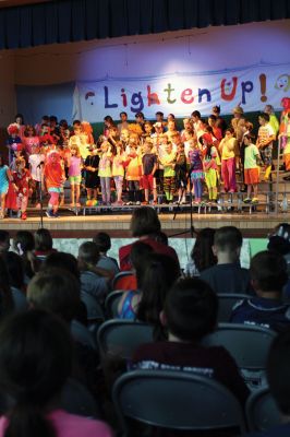 Lighten Up
Third-graders on June 16 performed their play “Lighten Up,” donning rainbow wigs, gigantic glasses, tutus, and brightly colored mustaches to remind everyone to not take themselves so seriously all the time. The students sang silly songs, told jokes, and offered some valuable advice like, “When life makes you sweat, wear deodorant!” By Jean Perry

