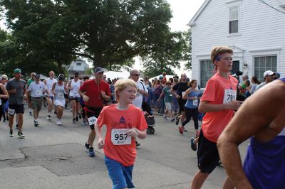 48th Annual Mattapoisett Road Race 
The 48th Annual Mattapoisett Road Race once again brought out young and old alike. Overcast skies were welcomed but the July 4th heat was tough for the runners and the cheering crowds who begged for shade. The field of runners was well over 1,000 and coming in first was Joe Farrand at 26:59. Shortly after, the first female to finish was Kim Bolick at 29:54. Before the starting gun sounded there was a moment of silence in honor of Maurice “Mudgie” Tavares who established the Mattapoisett Track Club, and the 
