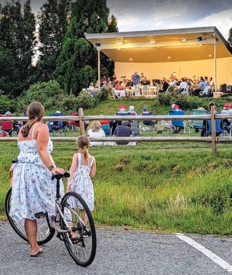 Marion Concert Band
A mother and daughter in matching dresses take in the music of the Marion Concert Band, who performed a riveting assortment of songs influenced by Latin traditions at the Island Wharf on Friday, August 14. Photo by Jeanne Hopkins.
