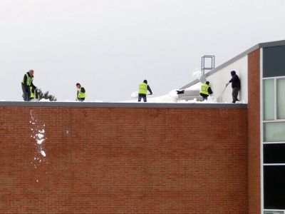Snow Roof
School was canceled at ORR on February 23 due to a possible structural issue with the roof. Workers shoveling snow off the roof found a questionable area that might have buckled beneath the weight of the snow. An engineer found no damage and school resumed again the next day. Photo by Art Hutchison
