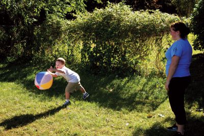 South Coast Special Olympics 
Volunteer Mackenzie Martins of New Bedford (right) watches Bennett Lawrence, 6, of New Bedford, catches a beach ball during the South Coast Special Olympics program, at Center School in Mattapoisett.  The activities were geared towards children ages 2-7.  Photo by Eric Tripoli. 
