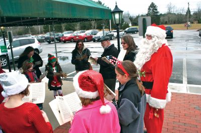 Plumb Corner Holiday
On December 10, 2011, Rev. Leo Christian of the Rochester First Congregational Church led a group of carolers at the Plumb Corner Holiday Celebration. Photo by Robert Chiarito.
