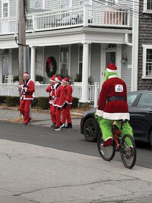 Mattapoisett Santa Stampede
The Mattapoisett Santa Stampede took place on Saturday, December 6 with over 300 Santas taking place. The 5K began at Shipyard Park and cut down Ned’s Point Road to the point, around the lighthouse and back. The Grinch led the pack on his bike, and residents stood by to cheer on all the runners. Photos by Sam Bishop and Mick Colageo
