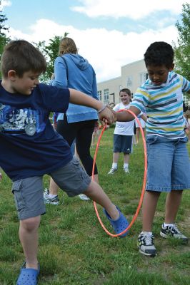 Field Day Fun at Sippican School 
Friday morning we caught some first-graders in the middle of a hula-hoop relay on the grounds of Sippican School. Holding hands and cheering each other on, the kids twisted and turned themselves through the hoops and the first team to get their hoop to travel down and up the line again won the relay. Can you guess which team won? Photo by Jean Perry
