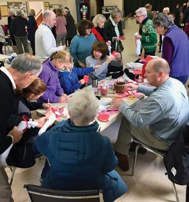 Socks of Love 
Mattapoisett Congregational Church thanks the community for its generosity and help in preparing Socks of Love for the homeless on Sunday, February 9. The church and community joined forces to deliver 60 pairs of socks to adults and 24 pairs to children in New Bedford. Each package included toiletries and a handwritten Valentine card. Photo courtesy Tina Zantrofski
