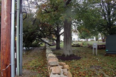 Storm Damage
An uprooted tree lays across the front lawn of a ranch house on Front Street near Silvershell Beach in Marion last Friday. Earlier in the day, a Mattapoisett Fire truck monitored the scene after a downed powerline caused a fire and closed Water Street down the street from Town Hall. North of Route 195 in Mattapoisett, a snapped-off tree is held up by a utility wire. Photos by Mick Colageo and Marilou Newell
