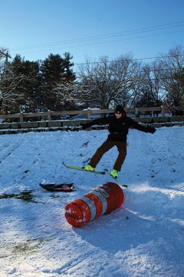 Ski Jumps
Tabor Academy sophomores Andrei Sarbu (yellow pants) and Joe Barry and friends enjoyed their Sunday afternoon, turning the little sledding slope on Spring Street at Tabor Academy’s soccer field into a ski jump. The two 16-year-olds took turns sticking landings from atop roadway barriers. Barry is from Falls Church, Virginia, and Sarbu is a native of Chico, California. Photos by Mick Colageo
