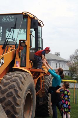 Second Annual Kid’s Equipment Day
Little kids and big, big machines on a warm spring Marion morning made for tons of fun at the Marion Recreation’s Second Annual Kid’s Equipment Day on May 10. A row of different Town-owned vehicles including a police cruiser, ambulance, earth diggers, a fire engine, and fire trucks lined the Town House field. There were plenty of Department of Public Works, police, and fire personnel on hand to demonstrate how the vehicles work, to turn on lights and alarms, and answer questions. Photo by Jean Perry
