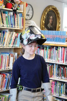 Strong as steel 
She’s got her heavy duty gloves, helmet, and her steel-toe boots, and she’s ready to show a group of boys and girls that welding is cool, fun, and definitely for girls. Rochester’s Emma Makuch, a freshman at Old Colony, is also a Junior Friend of the Plumb Library and on February 19 she shared her knowledge with a group of kids as part of the library’s February vacation lineup to keep kids entertained and learning. Photo by Jean Perry - February 21, 2019 edition
