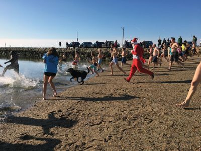 Christmas Day Swim
The 16th Annual Christmas Day Swim for Helping Hands and Hooves took place under bright blue cloudless skies and a balmy 43 degrees as dozens of families and friends took the plunge at Mattapoisett Town Beach. Photos by Marilou Newell
