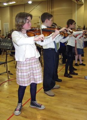 Student Notes
The Mattapoisett Center School Strings performed at the Friends of Old Rochester Music (FORM) Concert again this year at ORR High School. At left are third graders Dottie Vance and Sam Appleton. Marking tradition, all the tri-town bands joined together at the culmination of the concert. The concert, which was presented by the Old Rochester Regional Music Department, allows tri-town area music students to perform for and with each other while raising money for music scholarships. (Photo by Laura McLean).
