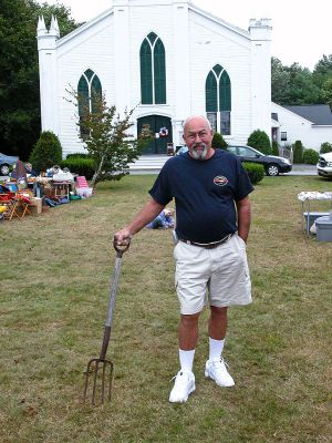 Pitchin' In
Doug McLaughlin of Rochester shows off the antique pitchfork he purchased for just $1 at the 33rd Annual Craft Fair and Flea Market held on the town green in front of the First Congregational Church in Rochester center. Despite some overcast weather, the fair was yet another success. (Photo by Robert Chiarito).
