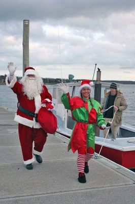 Here Comes Santa Claus
Jolly Saint Nick arrives via "water sleigh" in Sippican Harbor to pay an early Christmas visit to Marion residents during the annual Village Stroll held on Sunday, December 14. (Photo by Robert Chiarito).
