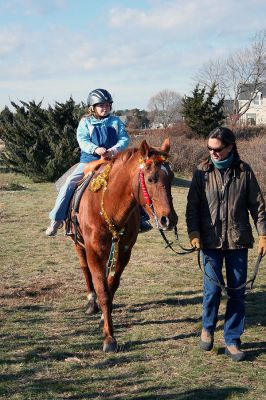 Holiday in the Park
Carissa Sullivan of Mattapoisett goes for a pony ride on "Copper" during Mattapoisett's Annual Holiday in the Park held on Saturday, December 6, 2008 in Shipyard Park. (Photo by Robert Chiarito).
