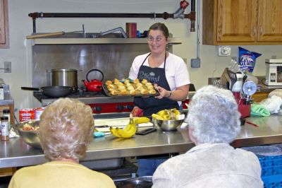 Cooking Class
Rochester resident Linda Medeiros took time out from her usual duties demonstrating Pampered Chef products to show participants at the Rochester Senior Center how to cook up a couple of delicious delights on Monday, November 13. Here she shows off her finished "Rosemary Parmesan Pinwheels." (Photo by Kenneth J. Souza).
